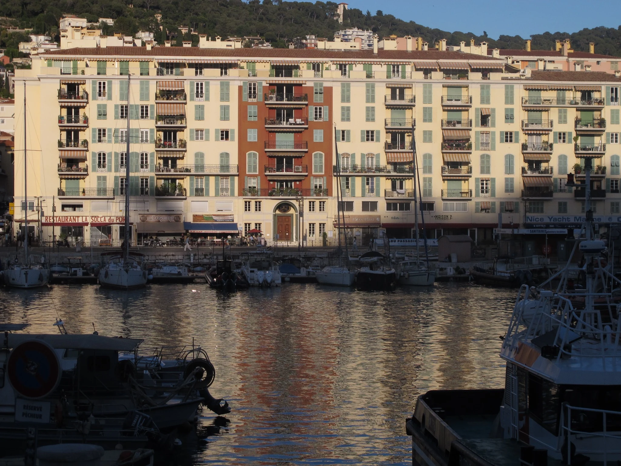 Pastel buildings and boats at the port of Nice